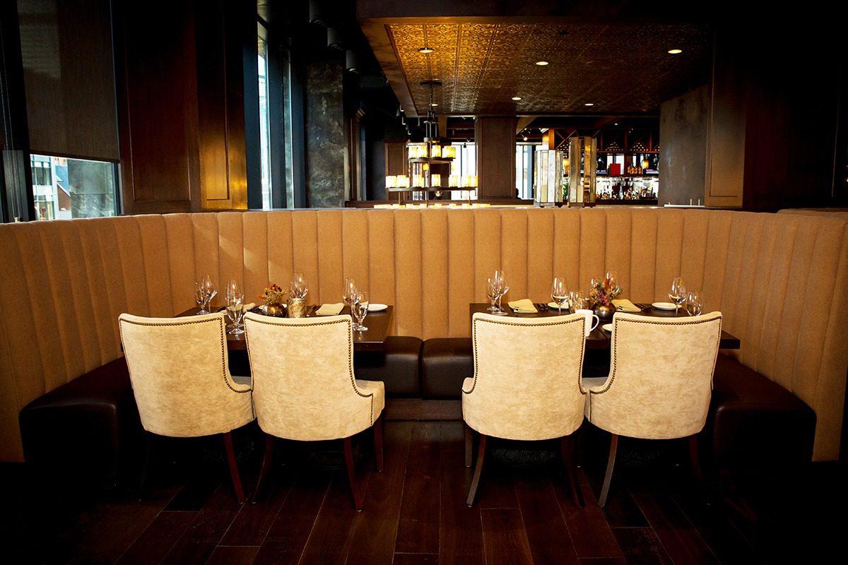 Elegant dining area with beige chairs and wooden accents.
