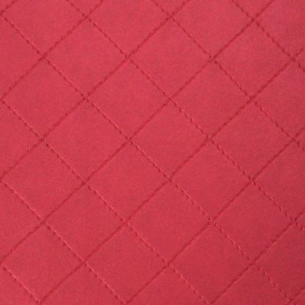 Red quilted fabric with diamond stitching pattern.