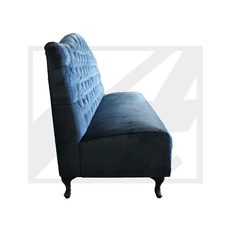 Elegant blue velvet tufted sofa with wooden legs.