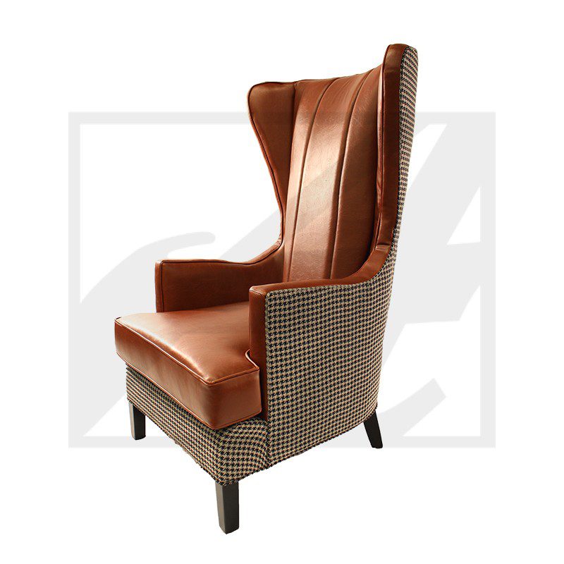 Elegant wingback chair with leather upholstery and woven sides.