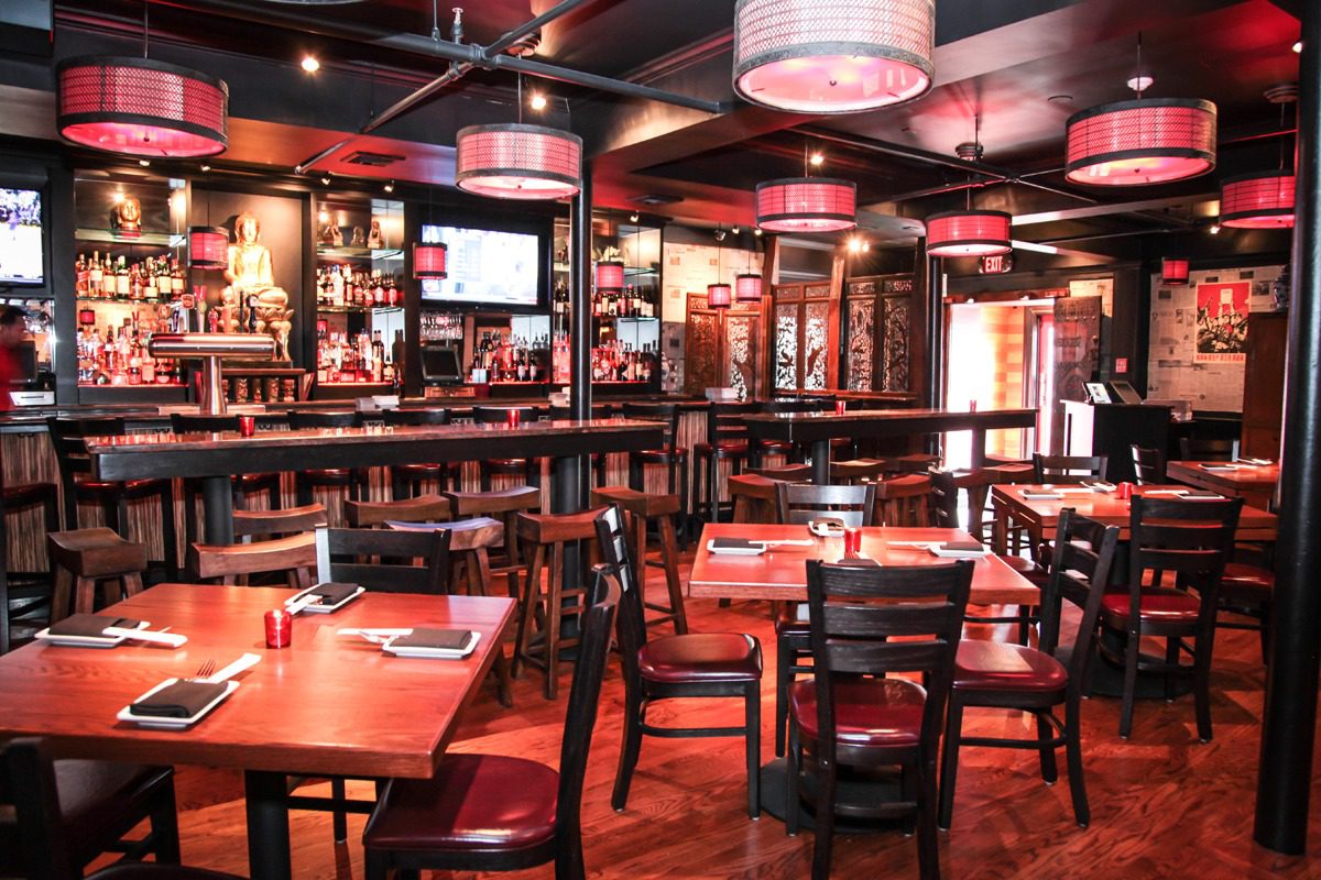 Cozy restaurant interior with wooden tables and chairs.