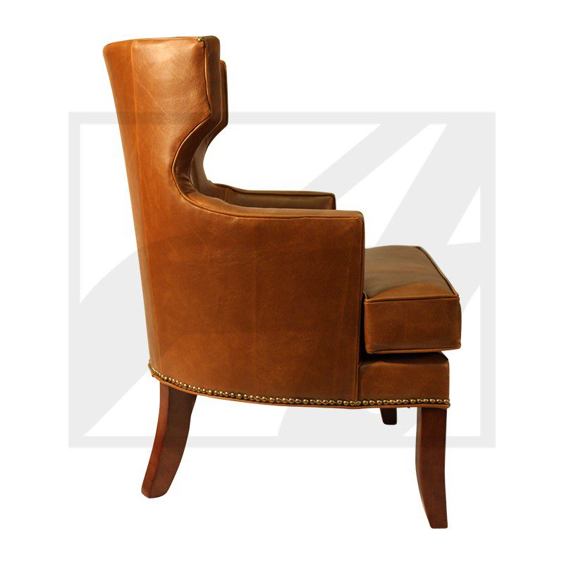 Side view of a brown leather armchair with wooden legs.