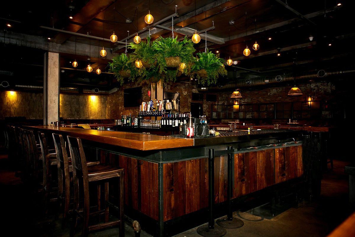 Cozy rustic bar with warm lighting and wooden decor.