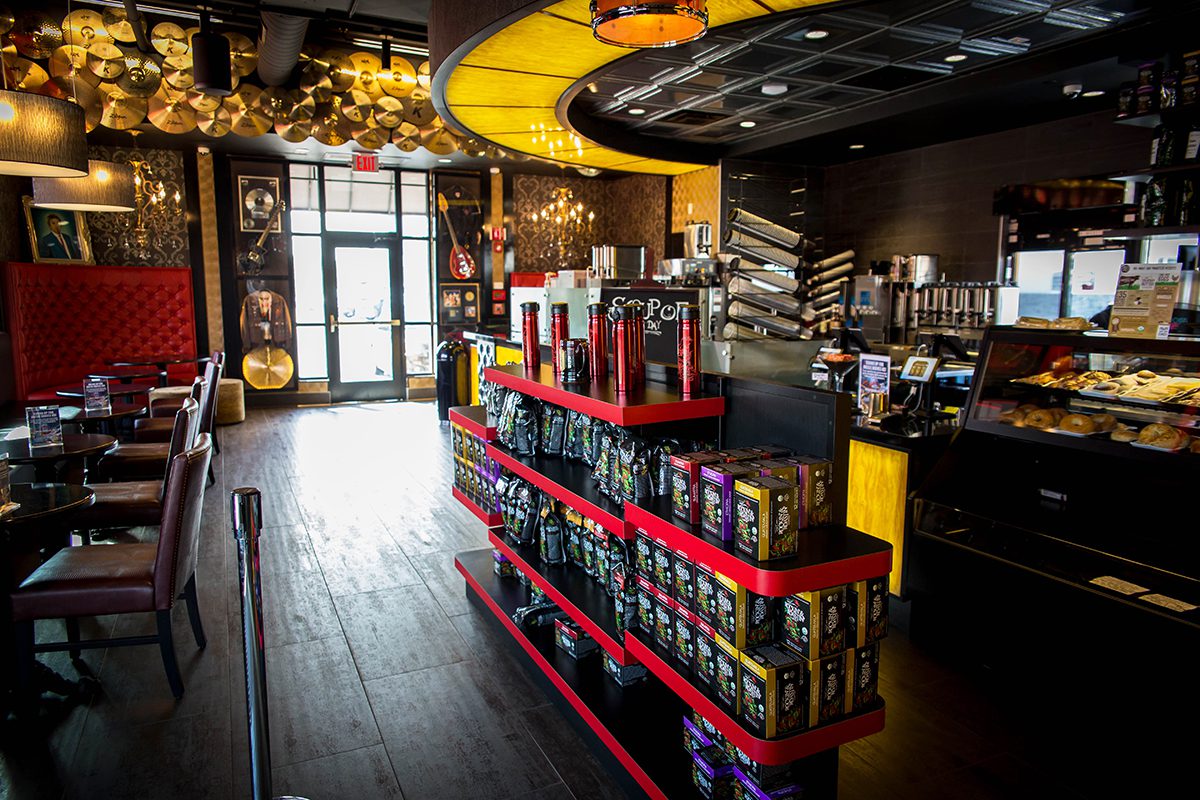 Cozy coffee shop interior with warm lighting and product displays.