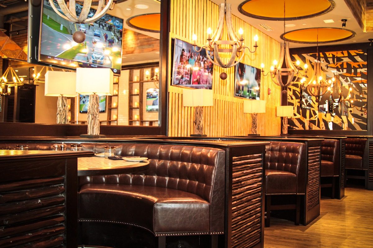 Cozy restaurant booth with leather seating and warm lighting.