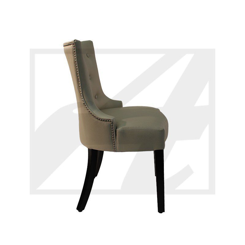 Side view of an upholstered dining chair with dark wooden legs.