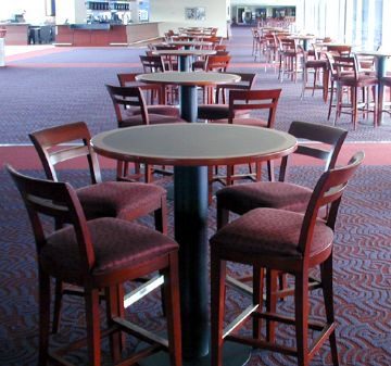 A round table with four cushioned chairs in a spacious dining area.