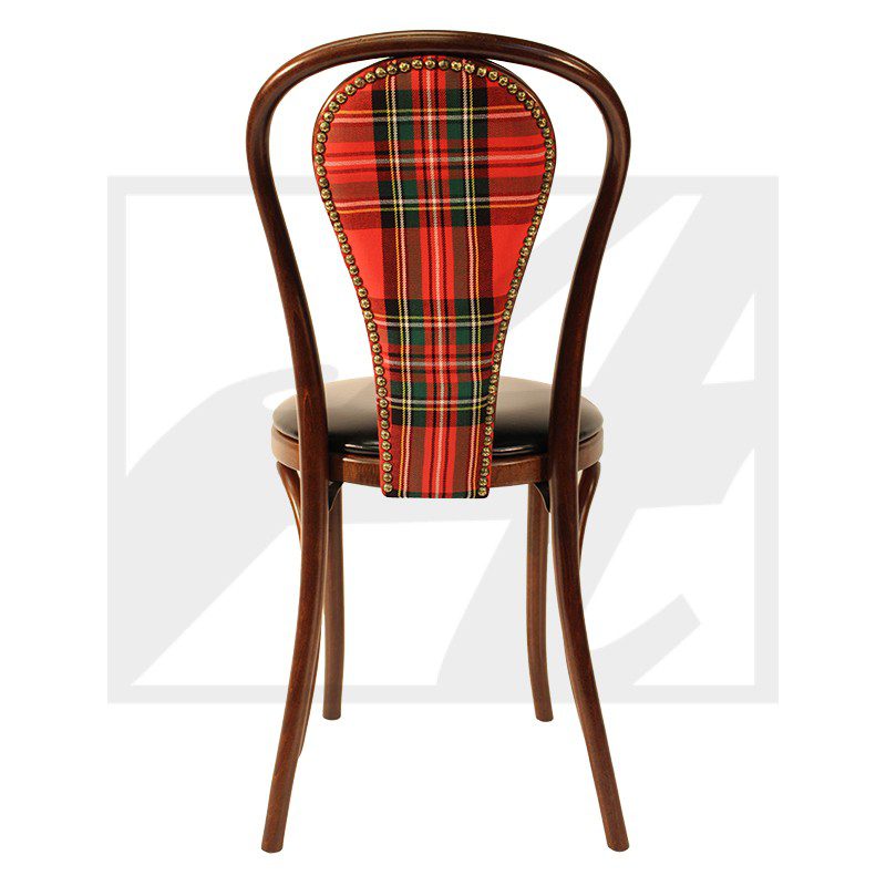 Wooden chair with a red plaid fabric backrest.