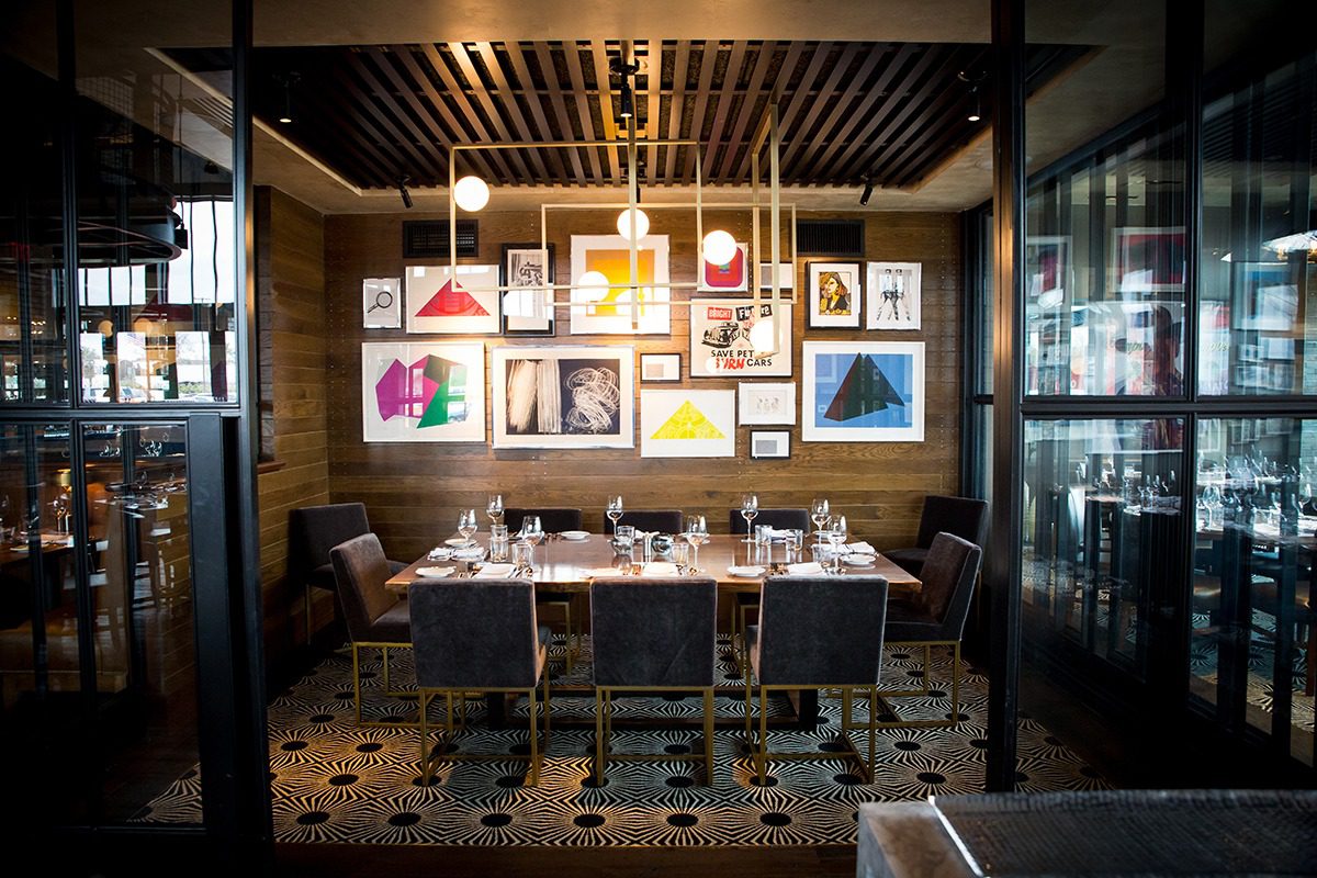 Cozy dining area with framed art and warm lighting.