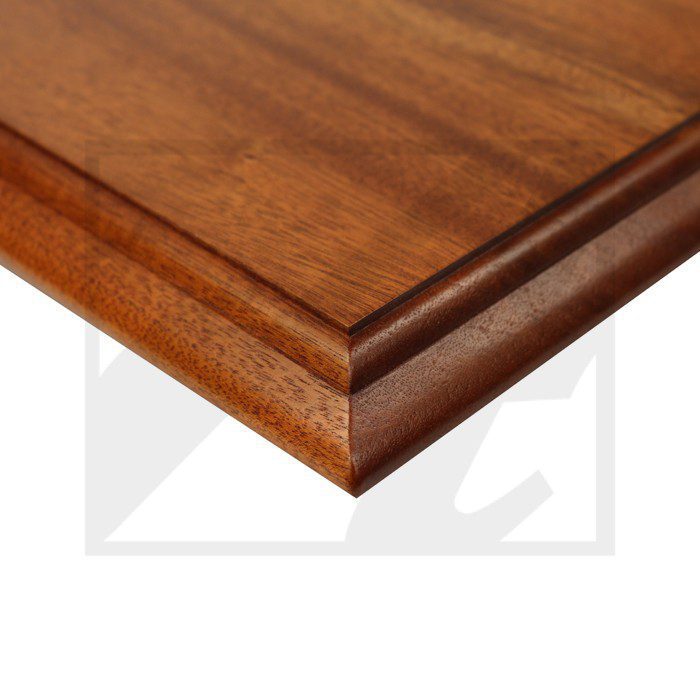 Close-up of a polished wooden tabletop corner with beveled edges.