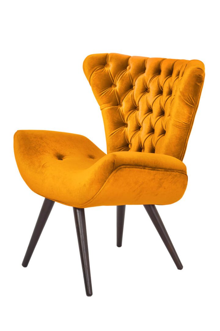 A mustard yellow upholstered armchair with a tufted back and wooden legs.
