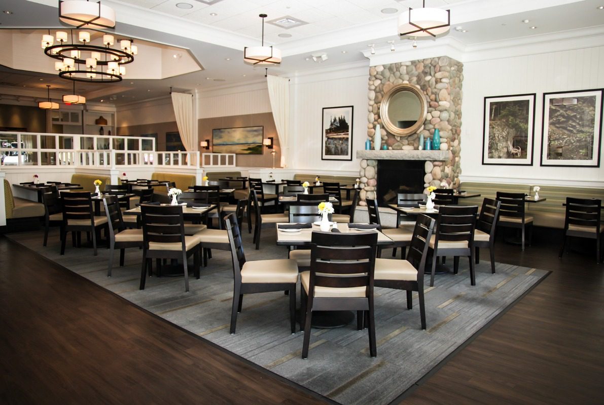 Elegant dining room with neatly arranged tables and chairs.