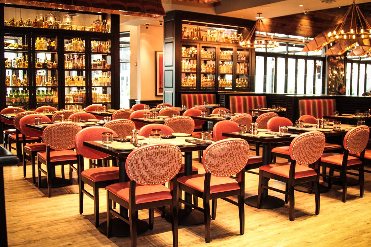 Elegant restaurant interior with warm lighting and plush seating.