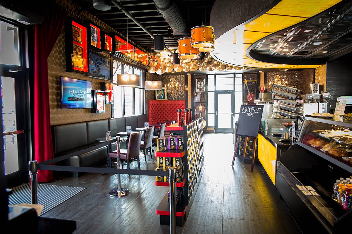 Cozy modern restaurant interior with vibrant lighting and stylish decor.