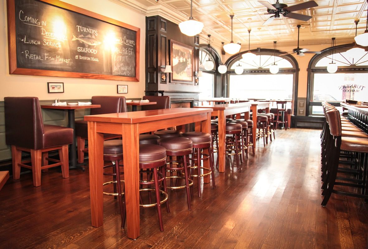 Cozy restaurant interior with wooden tables and chairs.