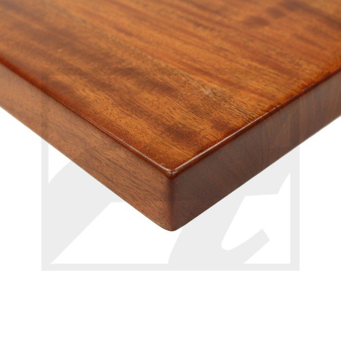 Close-up of a polished wooden table corner with smooth edges.
