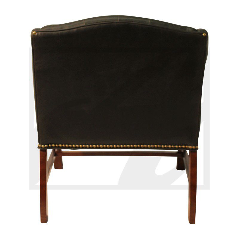 Back view of a black upholstered chair with wooden legs.