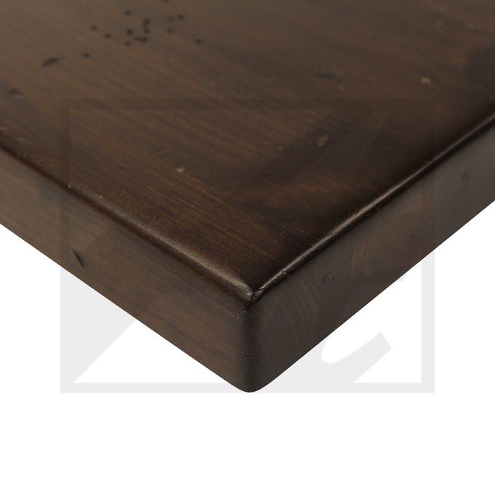 Close-up of a dark wooden tabletop corner with a smooth finish.