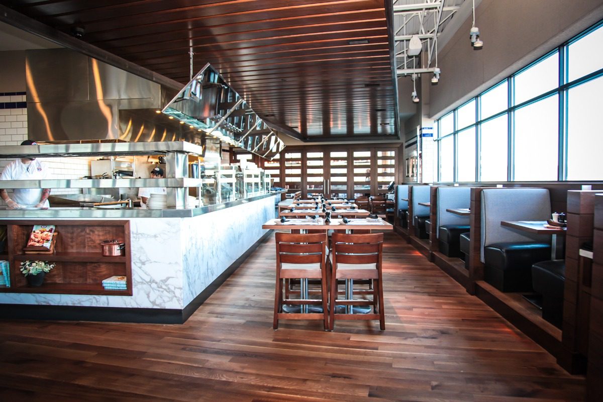 Modern restaurant interior with wooden floors and stylish seating.