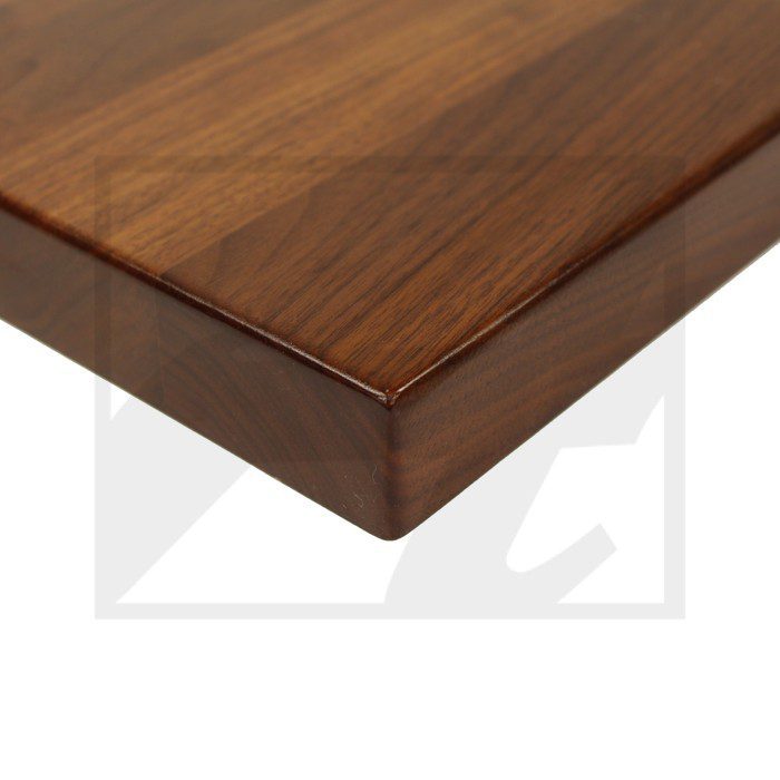 Close-up of a polished wooden tabletop corner with smooth edges.