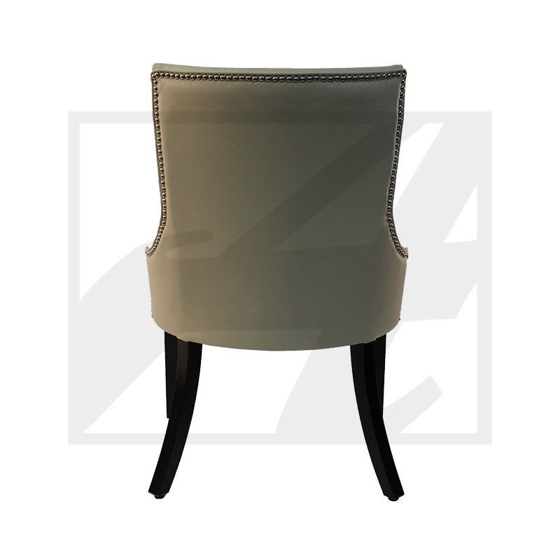Back view of a beige upholstered chair with dark wooden legs.