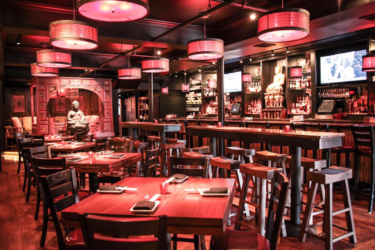 Cozy restaurant interior with warm lighting and wooden furniture.
