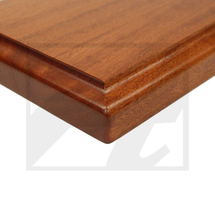 Close-up of a polished wooden furniture edge with beveled detailing.