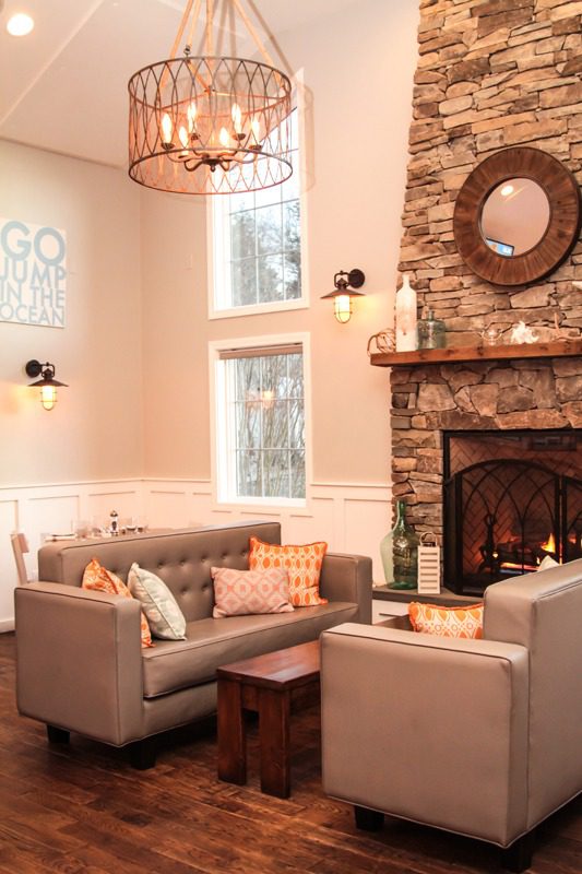 Cozy living room with stone fireplace and warm lighting.