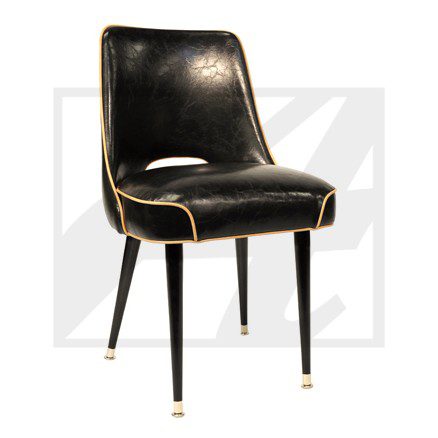 Sleek black leather chair with gold accents and tapered legs.