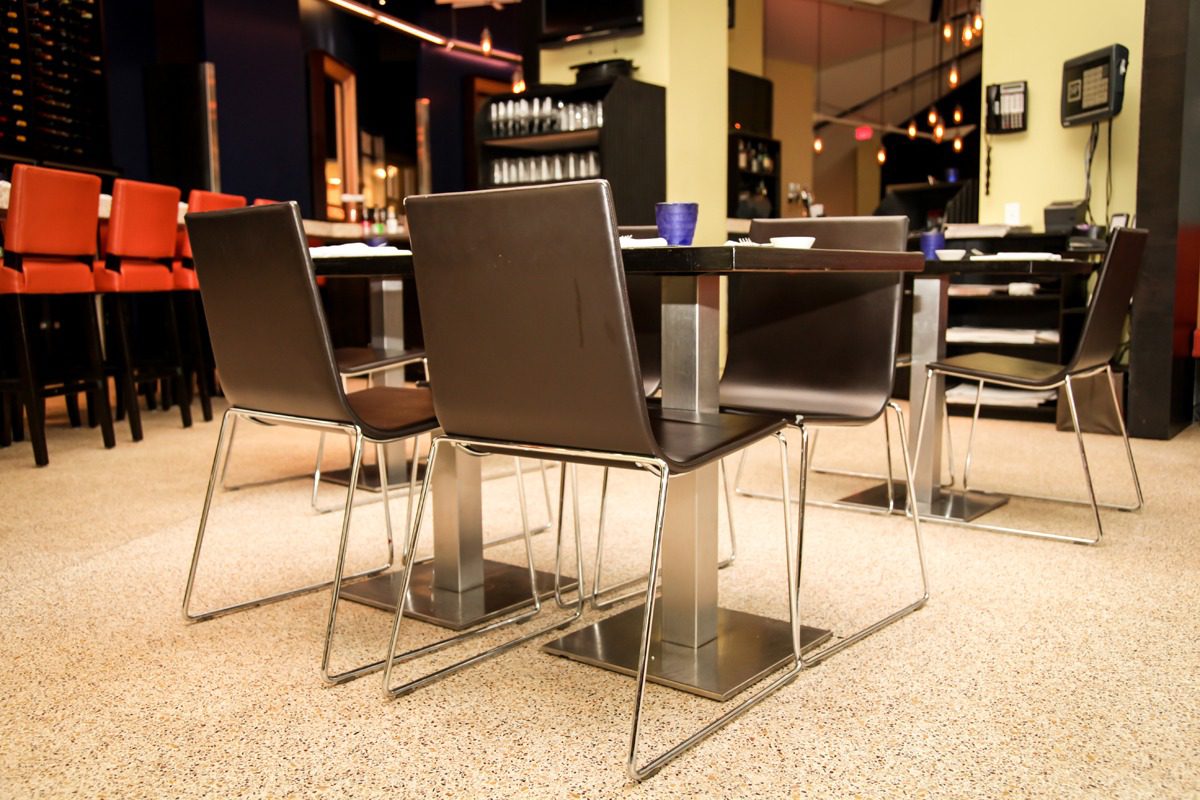 Modern dining table with sleek chairs in a cozy restaurant.