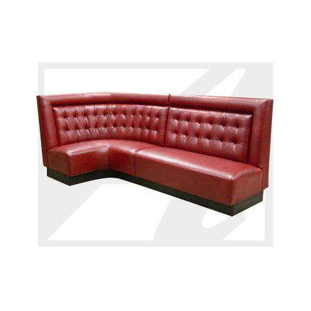 Red leather corner booth seating with tufted backrest.