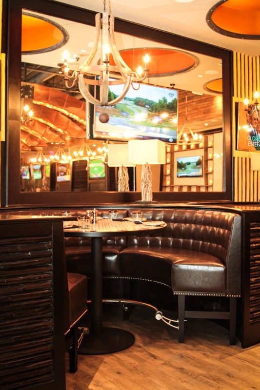 Cozy restaurant booth with leather seating and warm lighting.