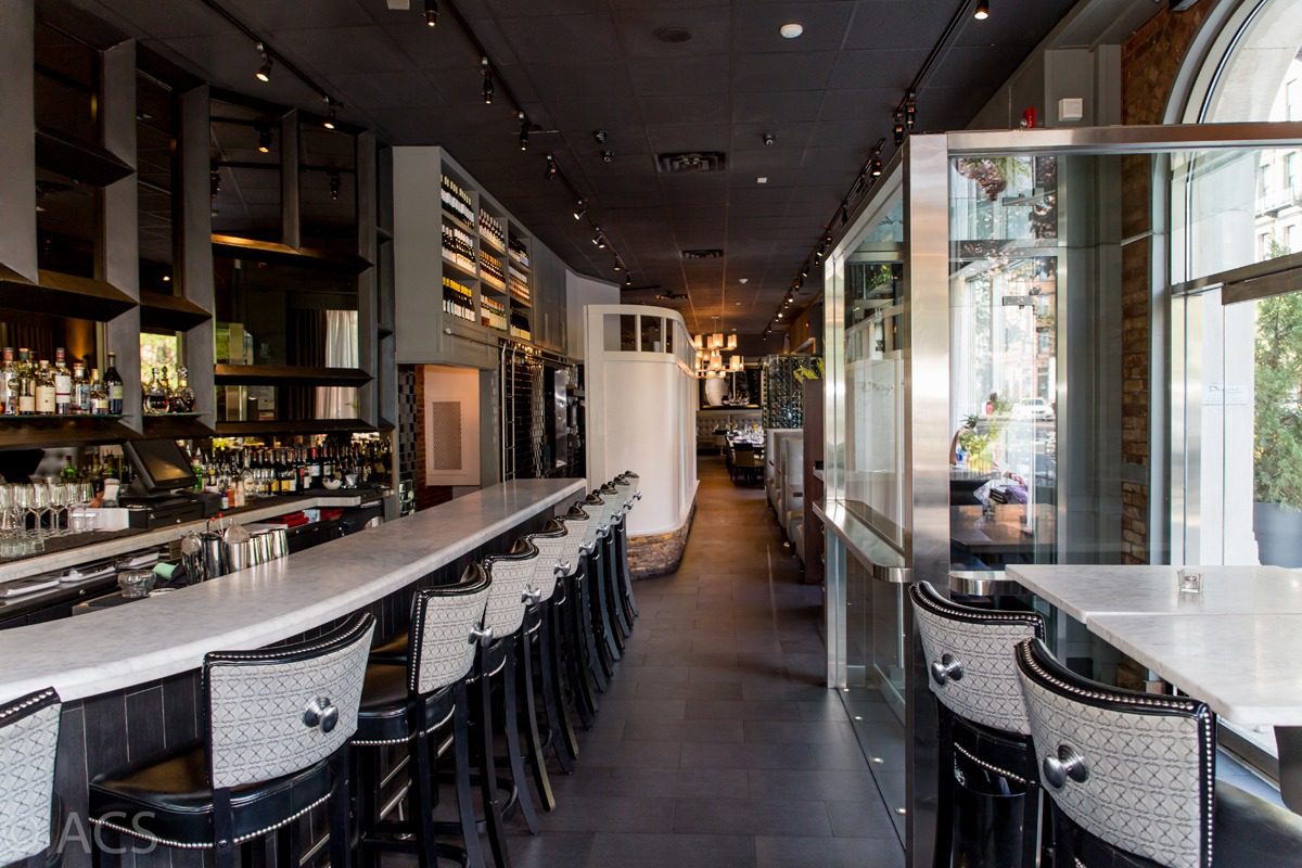 Modern bar with high stools and a sleek interior design.