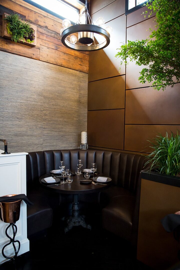 Cozy corner booth with a round table in a modern restaurant.