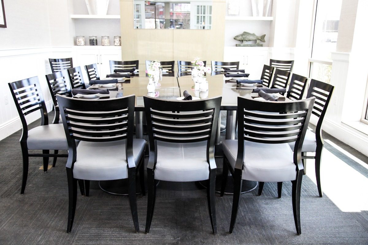Elegant dining room with a modern wooden table and cushioned chairs.