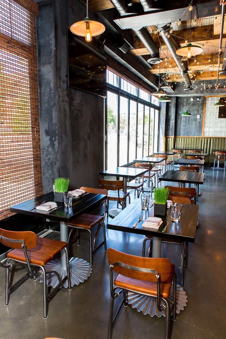 Modern industrial-style café with wooden tables and natural light.