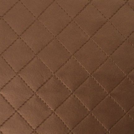Close-up of brown quilted fabric with diamond pattern.